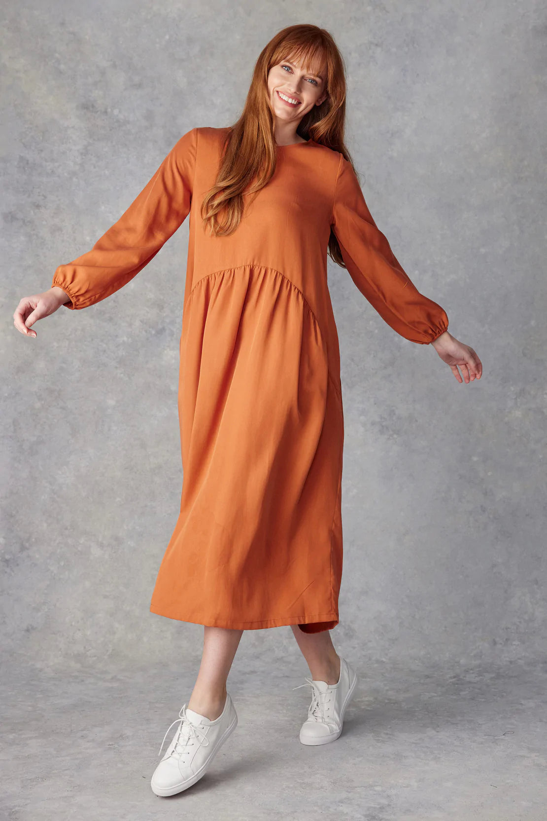 Burnt Orange Nellie dress is simply gorgeous, with a quality winter weight, long sleeves and flattering shaped waist line. Made from natural tencel with a silk-like feel with  pockets! 